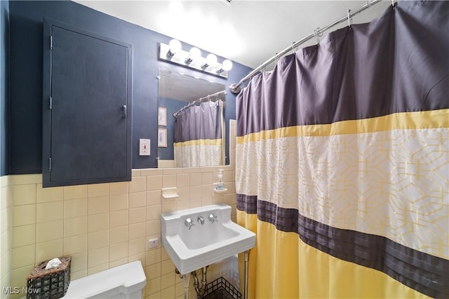 19901 Van Aken Blvd Unit 7, Shaker Heights, OH 44122 - bathroom featuring tile walls, a sink, a wainscoted wall, and a shower with shower curtain