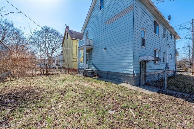 view of home's exterior with fence and a gate