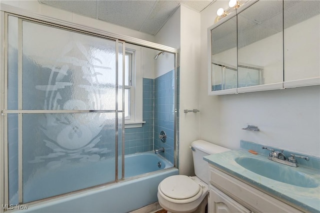 full bath featuring toilet, shower / bath combination with glass door, and vanity