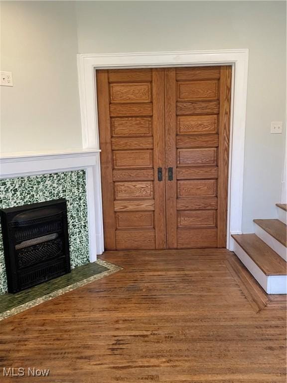 3217 W 14th St, Cleveland, OH 44109 - foyer entrance with wood finished floors, a tiled fireplace, and stairway