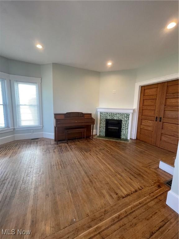 3217 W 14th St, Cleveland, OH 44109 - living area featuring wood-type flooring, a tile fireplace, baseboards, and recessed lighting