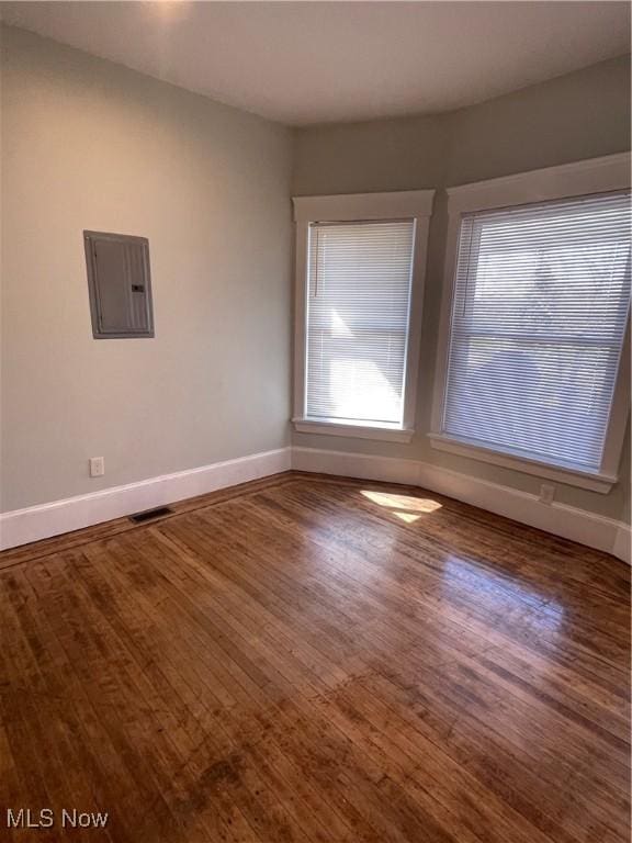 3217 W 14th St, Cleveland, OH 44109 - empty room featuring electric panel, baseboards, and wood finished floors