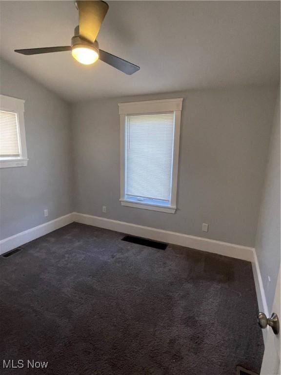 3217 W 14th St, Cleveland, OH 44109 - empty room featuring dark carpet, ceiling fan, and baseboards