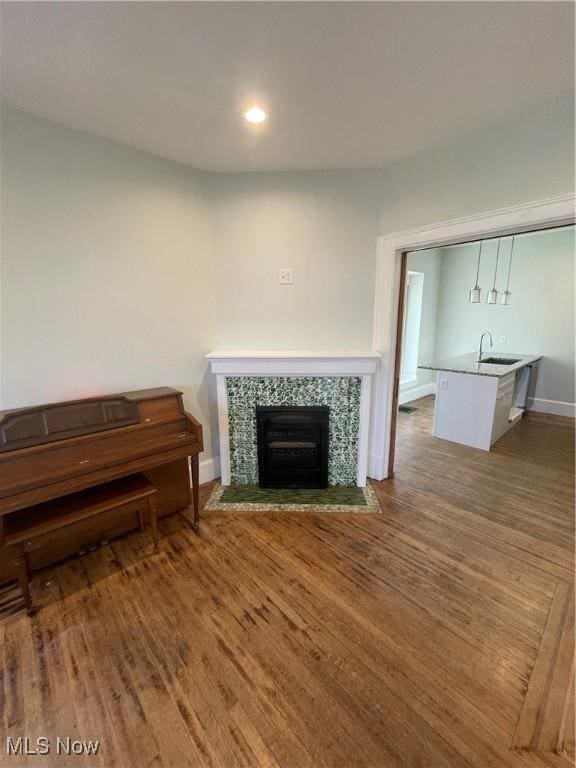 3217 W 14th St, Cleveland, OH 44109 - living room with a tile fireplace, wood finished floors, baseboards, and recessed lighting