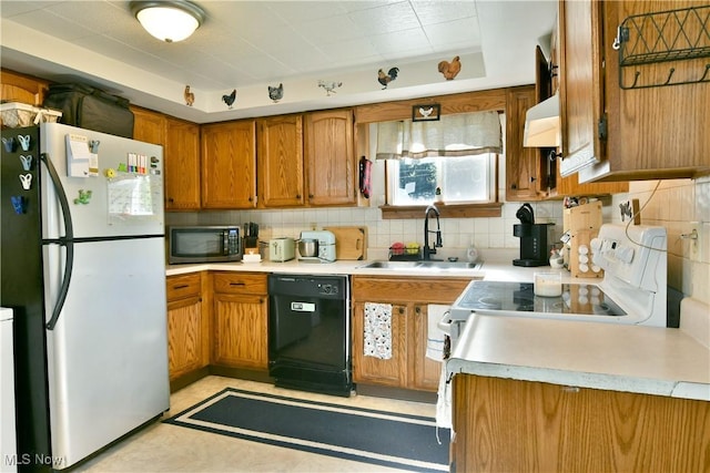 3122 Mccleary Jacoby Rd, Cortland, OH 44410 - kitchen with freestanding refrigerator, black dishwasher, a sink, and brown cabinetry