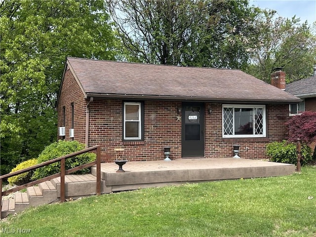 385 Truax Ln, Weirton, WV 26062 - view of front of property with brick siding, roof with shingles, a front lawn, and a deck