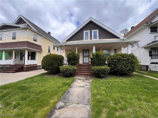 11919 Browning Ave, Cleveland, OH 44120 - bungalow-style home with covered porch and a front yard