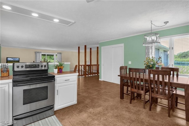 1060 S Watkins Rd, Alexandria, OH 43001 - kitchen featuring stainless steel electric range oven, light countertops, white cabinetry, recessed lighting, and decorative light fixtures
