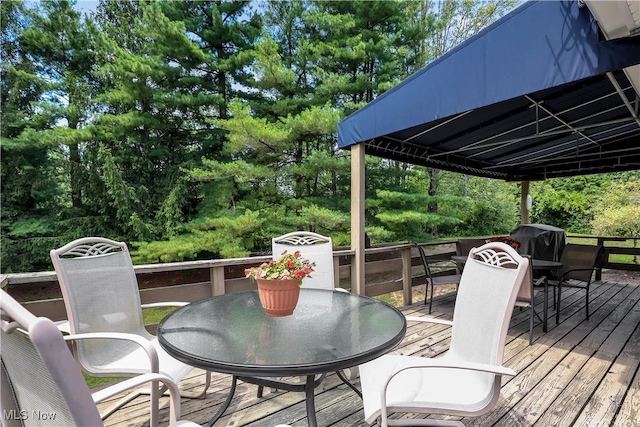 1060 S Watkins Rd, Alexandria, OH 43001 - wooden deck with outdoor dining space and view of wooded area
