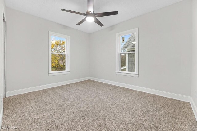 38 W Washington St, Alliance, OH 44601 - carpeted empty room with baseboards and a ceiling fan