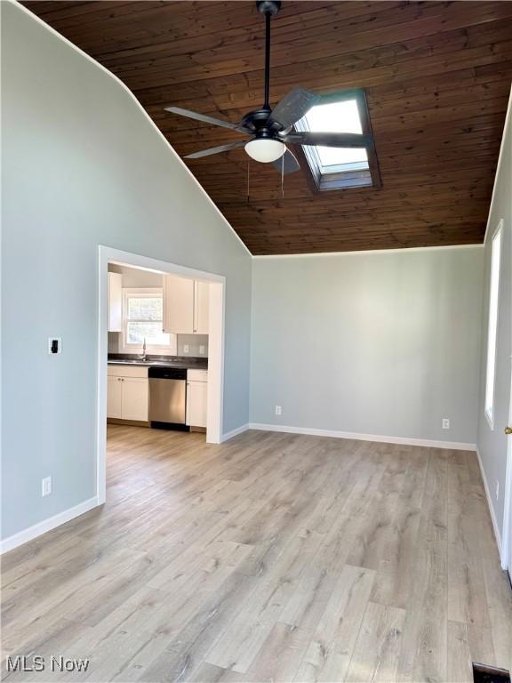 1226 E Main St, Coshocton, OH 43812 - unfurnished living room with wood ceiling, ceiling fan, high vaulted ceiling, baseboards, and a sink