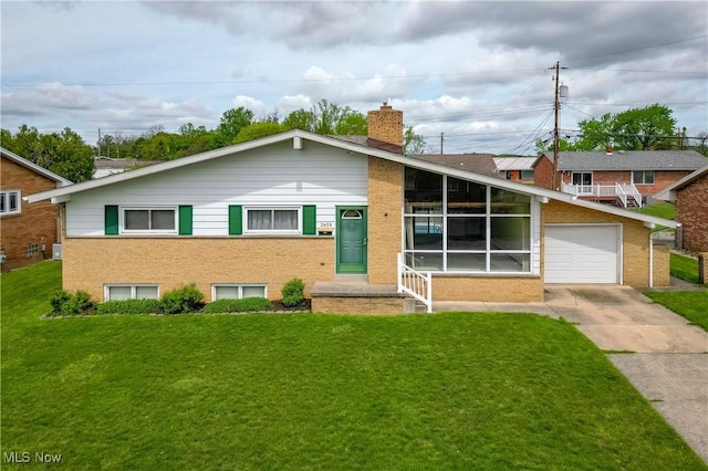 2455 Alexander Mnr E, Steubenville, OH 43952 - view of front of property featuring driveway, brick siding, a chimney, a front yard, and a garage