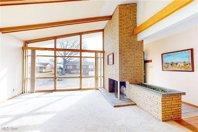 2455 Alexander Mnr E, Steubenville, OH 43952 - carpeted living room with beamed ceiling, a brick fireplace, high vaulted ceiling, and floor to ceiling windows