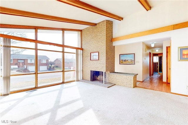2455 Alexander Mnr E, Steubenville, OH 43952 - unfurnished living room featuring carpet floors, beamed ceiling, a brick fireplace, and baseboards