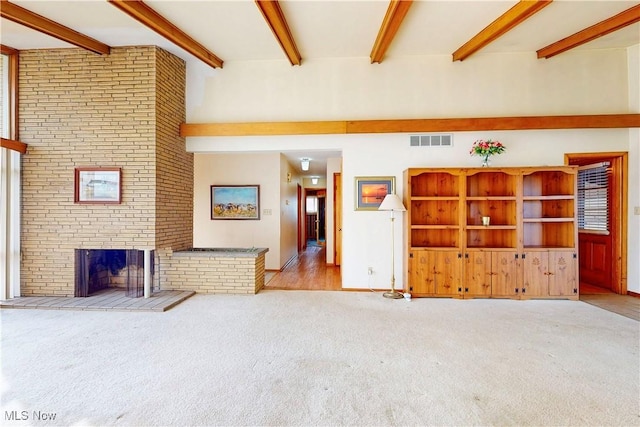 2455 Alexander Mnr E, Steubenville, OH 43952 - unfurnished living room featuring carpet floors, beamed ceiling, a brick fireplace, and baseboards
