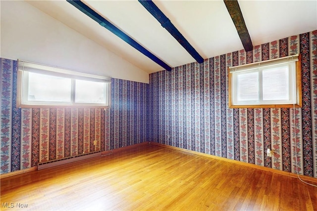 2455 Alexander Mnr E, Steubenville, OH 43952 - empty room with wood finished floors, a baseboard radiator, healthy amount of natural light, wallpapered walls, and baseboards