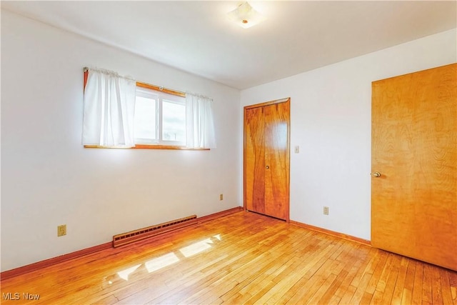 2455 Alexander Mnr E, Steubenville, OH 43952 - unfurnished bedroom with hardwood / wood-style flooring, baseboards, and a closet