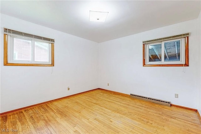 2455 Alexander Mnr E, Steubenville, OH 43952 - spare room featuring a baseboard heating unit, wood-type flooring, and baseboards