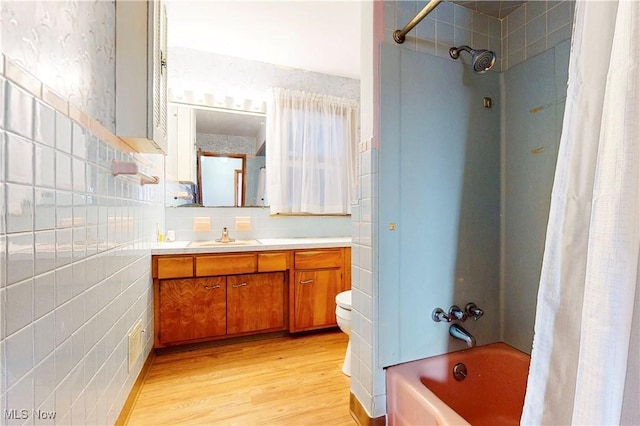 2455 Alexander Mnr E, Steubenville, OH 43952 - bathroom with wood finished floors, shower / bath combo, vanity, decorative backsplash, and toilet