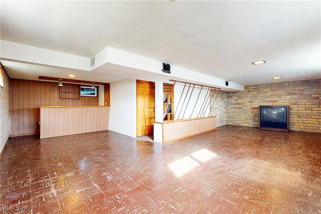 2455 Alexander Mnr E, Steubenville, OH 43952 - unfurnished living room featuring wood walls