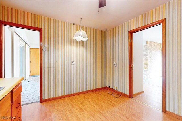 2455 Alexander Mnr E, Steubenville, OH 43952 - spare room with wallpapered walls, light wood-style floors, a ceiling fan, and baseboards