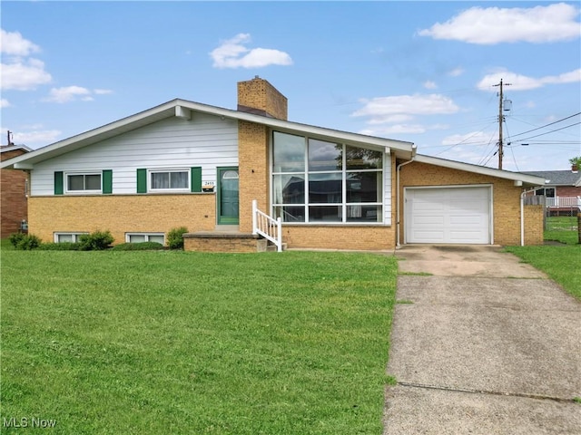 2455 Alexander Mnr E, Steubenville, OH 43952 - view of front of house with brick siding, concrete driveway, and a front lawn