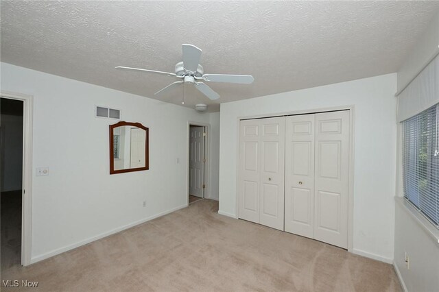 4212 Castle Rdg, Copley, OH 44321 - unfurnished bedroom featuring light colored carpet, a closet, baseboards, ceiling fan, and a textured ceiling