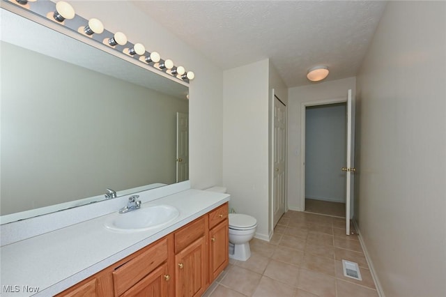 4212 Castle Rdg, Copley, OH 44321 - bathroom featuring toilet, vanity, tile patterned flooring, a textured ceiling, and baseboards