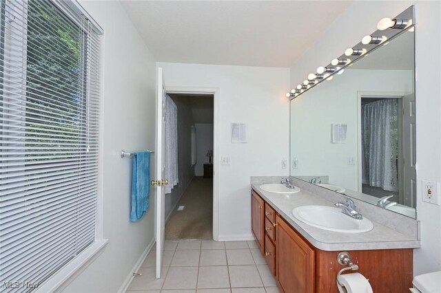 4212 Castle Rdg, Copley, OH 44321 - full bathroom with healthy amount of natural light, double vanity, tile patterned floors, and baseboards