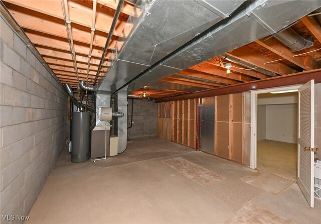 4212 Castle Rdg, Copley, OH 44321 - unfinished basement featuring gas water heater, heating unit, and concrete block wall