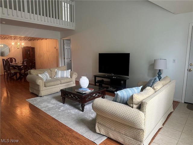 4212 Castle Rdg, Copley, OH 44321 - living area with a towering ceiling, a chandelier, and light wood finished floors
