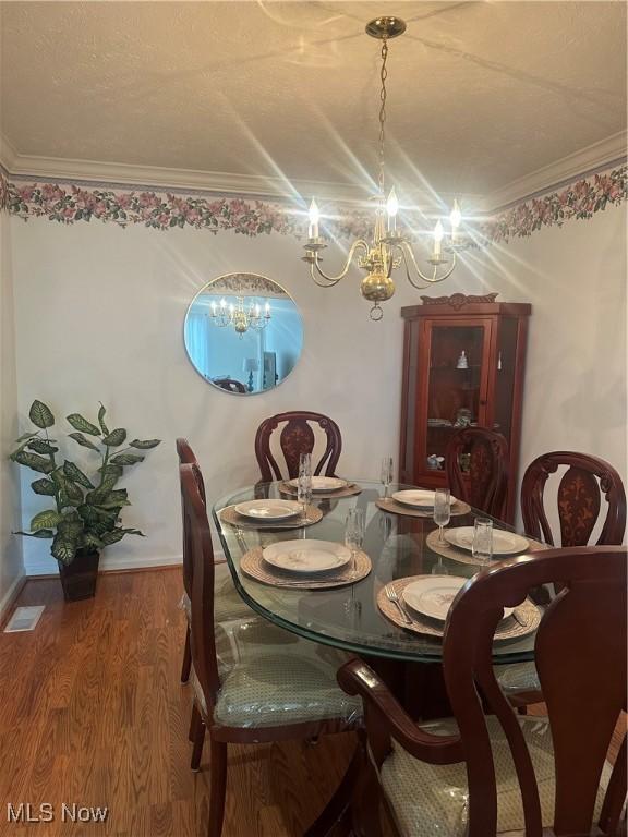 4212 Castle Rdg, Copley, OH 44321 - dining room with a chandelier, wood finished floors, and ornamental molding