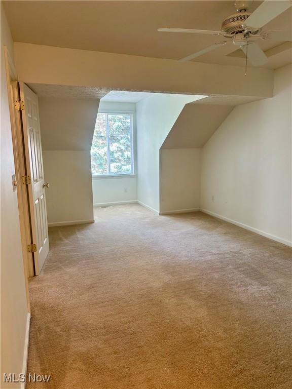 4212 Castle Rdg, Copley, OH 44321 - additional living space with baseboards, lofted ceiling, light colored carpet, and a ceiling fan