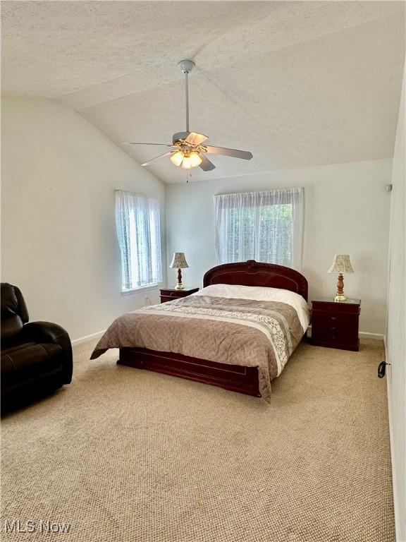 4212 Castle Rdg, Copley, OH 44321 - bedroom featuring carpet, vaulted ceiling, a ceiling fan, a textured ceiling, and baseboards