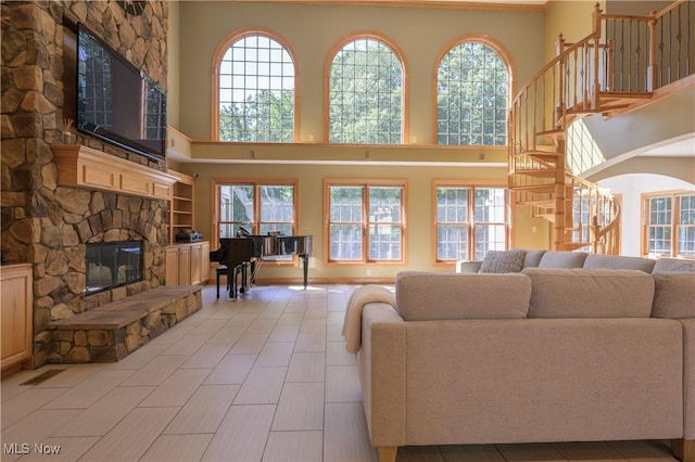6240 Tim Dr, Wadsworth, OH 44281 - living room featuring plenty of natural light, a stone fireplace, and a towering ceiling