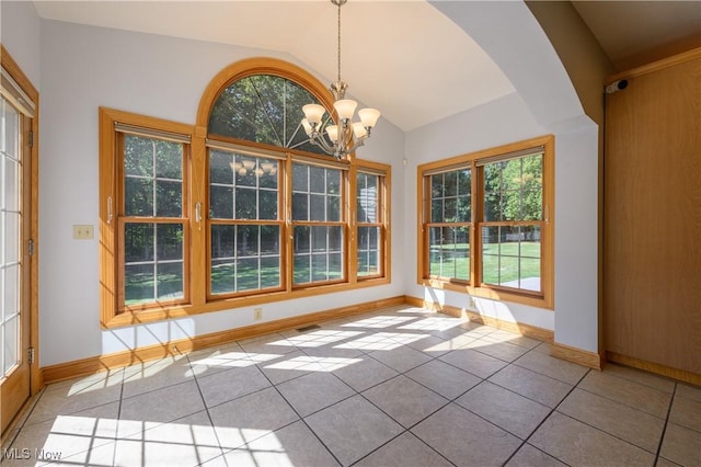 6240 Tim Dr, Wadsworth, OH 44281 - unfurnished dining area featuring a chandelier, plenty of natural light, vaulted ceiling, arched walkways, and light tile patterned flooring