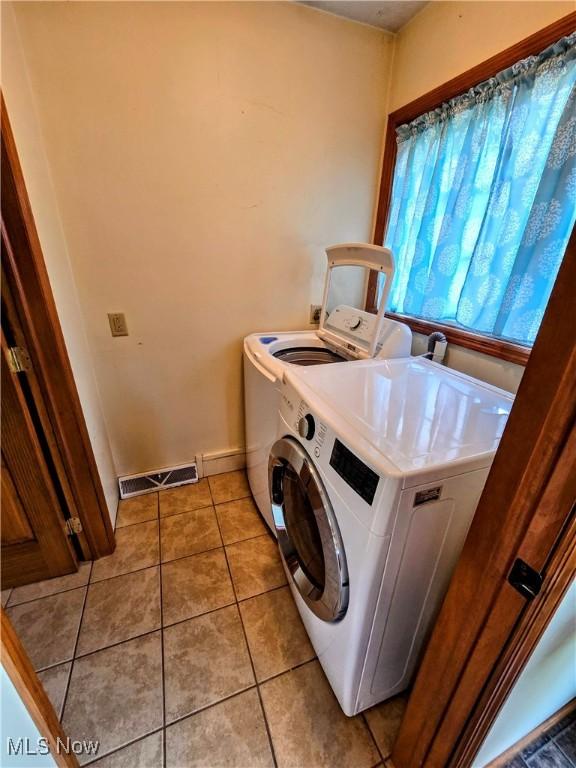 105 W 40th St, Shadyside, OH 43947 - laundry area featuring washing machine and dryer, light tile patterned floors, and baseboards