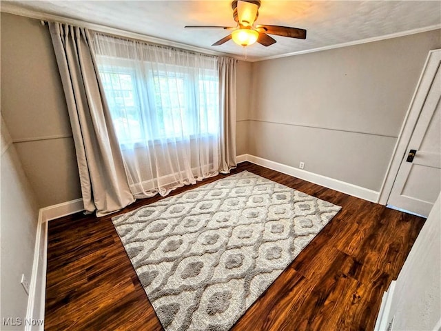105 W 40th St, Shadyside, OH 43947 - unfurnished bedroom with ornamental molding, dark wood-style floors, baseboards, and ceiling fan