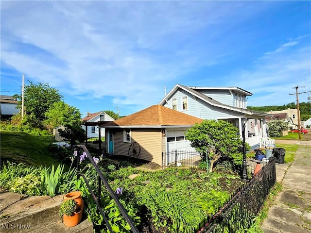 105 W 40th St, Shadyside, OH 43947 - view of property exterior with fence and an attached garage
