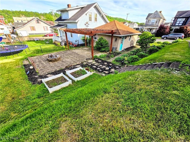 105 W 40th St, Shadyside, OH 43947 - rear view of house featuring an outdoor fire pit, a residential view, a vegetable garden, and a carport