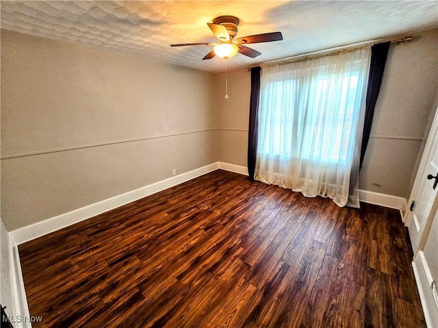 105 W 40th St, Shadyside, OH 43947 - unfurnished room with ceiling fan, baseboards, and dark wood-style floors