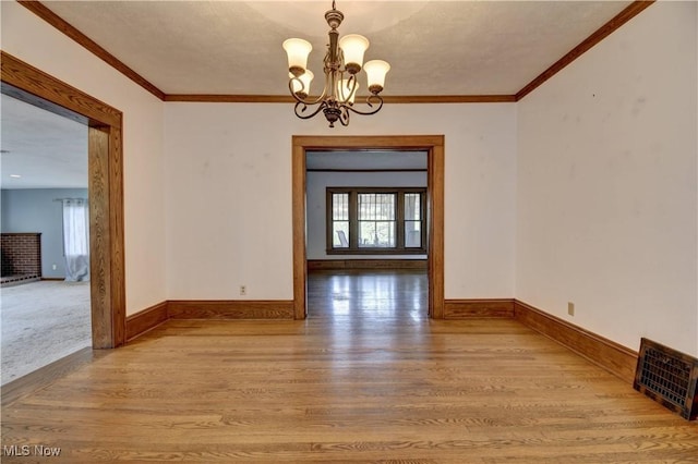 6456 Dover Zoar Rd NE, Dover, OH 44622 - unfurnished dining area with wood finished floors, a chandelier, baseboards, and crown molding