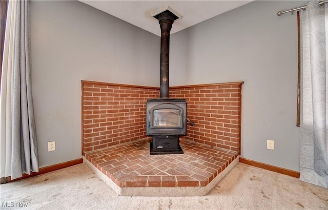 6456 Dover Zoar Rd NE, Dover, OH 44622 - detailed view of a wood stove, carpet floors, and baseboards