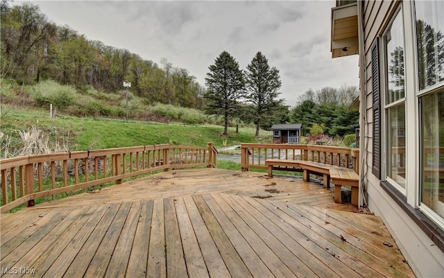 6456 Dover Zoar Rd NE, Dover, OH 44622 - deck featuring an outdoor structure, a storage unit, a yard, and view of scattered trees