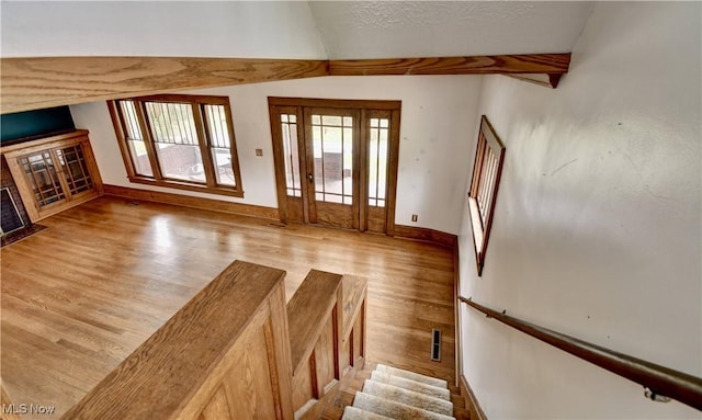 6456 Dover Zoar Rd NE, Dover, OH 44622 - entryway featuring light wood-style floors, baseboards, vaulted ceiling, and stairway
