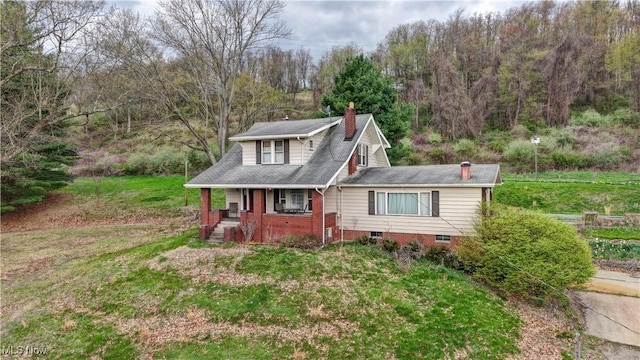 6456 Dover Zoar Rd NE, Dover, OH 44622 - view of front of home featuring a porch, a chimney, a front yard, and crawl space