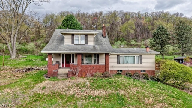6456 Dover Zoar Rd NE, Dover, OH 44622 - view of front of house featuring covered porch, a chimney, and a view of trees