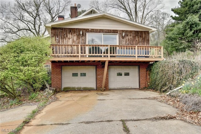 6456 Dover Zoar Rd NE, Dover, OH 44622 - view of front of property with concrete driveway, brick siding, a garage, and a chimney