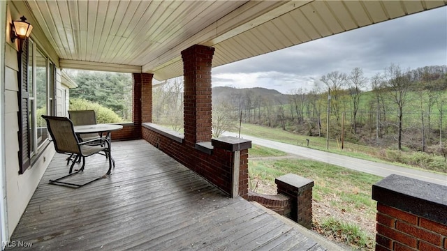 6456 Dover Zoar Rd NE, Dover, OH 44622 - wooden deck with covered porch and a wooded view