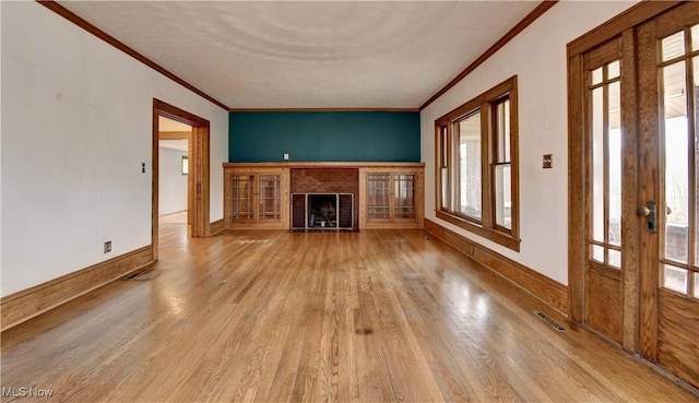 6456 Dover Zoar Rd NE, Dover, OH 44622 - unfurnished living room featuring ornamental molding, wood finished floors, a fireplace, french doors, and baseboards